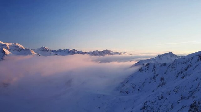Snow covered mountains under a vibrant sunset sky