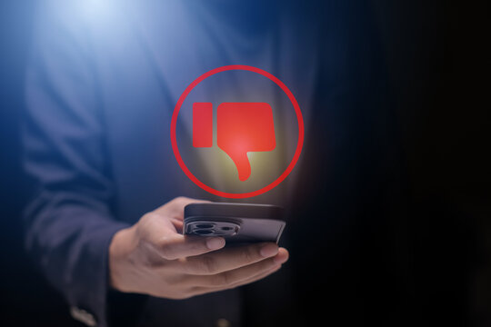 Man using smartphone or tablet, pointing finger at dislike button, thumbs down button, Interface,Thumbs up icon, display screen, touch screen, Virtual Image Technology