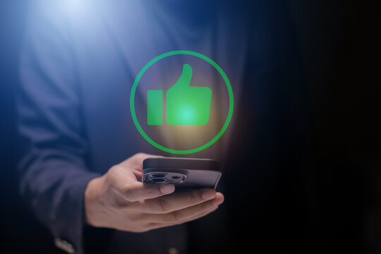Man using smartphone or tablet, pointing finger at like button, thumbs down button, Interface,Thumbs up icon, display screen, touch screen, Virtual Image Technology