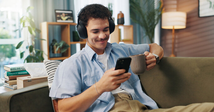 Headphones, man and smile with phone on sofa for streaming service, watching online video and coffee break. Relax, person and smartphone in home for audio playlist, music album or internet connection