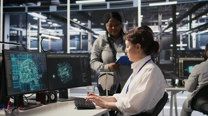 Data center software developer using PC to monitor neural network AI visualization. Woman working in server room using computer to oversee rigs powering machine learning processes, camera A - Powered by Adobe