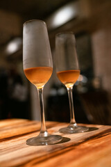 Chilled Champagne Glasses on Wooden Table – Intimate Night Celebration