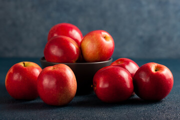 Bowl of Red Apples on Blue Background