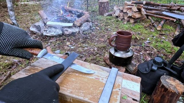 Sharpening a knife outdoors with a sharpener