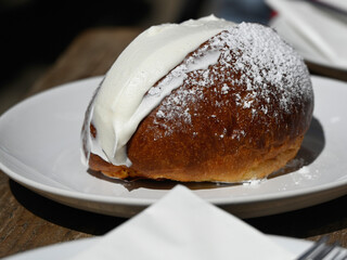 Italian Cream Bun (Maritozzo) on white plate