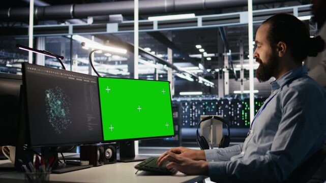 Data center technician doing software updates using green screen mockup computer. Server room IT specialist , optimizing infrastructure using chroma key isolated screen PC, camera A