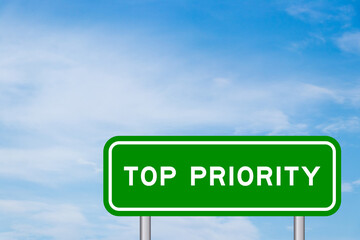 Green color transportation sign with word top priority on blue sky with white cloud background