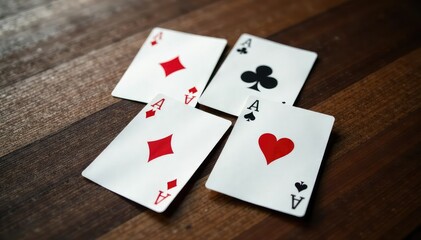 Four aces forming a square pattern on a wooden surface , cards layout, four of a kind