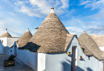 old mediterranean town with old beautiful houses with white walls and pretty tile roofs with ...