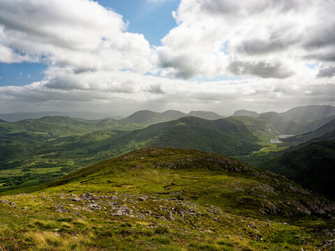 Explore the tranquil beauty of Blackvalley in Ireland under a vibrant sky filled with clouds.