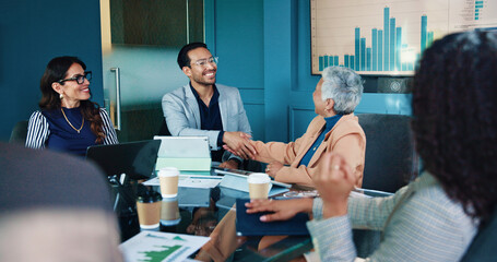 Business people, meeting and handshake with statistics for partnership, agreement or deal at...