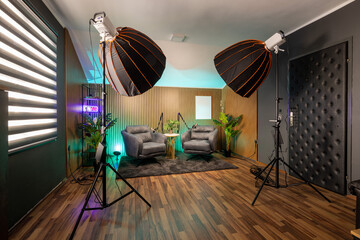 Professional podcast recording space with modern lighting and clean interior.