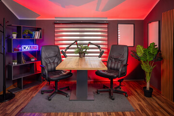 Stylish podcast studio interior with expert lighting for digital media production.