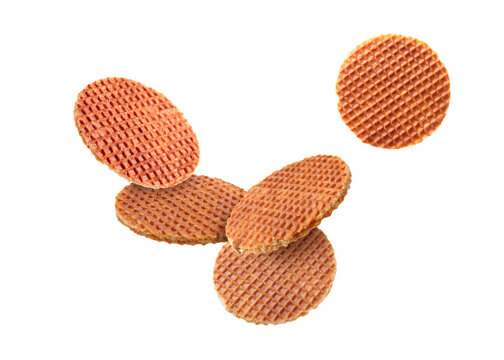 Yummy Dutch waffles (stroopwafels) flying on white background