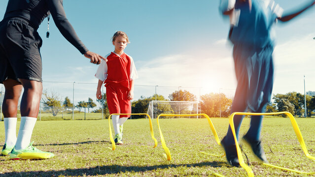 Coach, children and jump for soccer practice for fitness training, balance exercise and sports workout. Kids, drills and hurdles for playing game, learning skills and team challenge of match activity