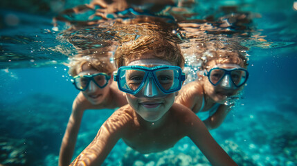Naklejka premium Children scuba diving underwater in a beautiful island beach.