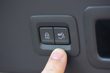 Finger near a power tailgate button