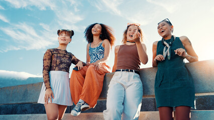 Low angle, fashion and friends laughing in city on bridge in cool clothes, casual outfit or modern...