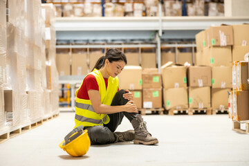A worker in a yellow vest sits on the floor, showcasing the reality of workplace injuries and the...