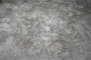 A grey concrete floor with a few scratches. The floor is very smooth and has no visible lines