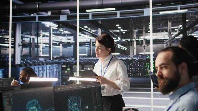 Data center team leader supervising system operations supporting neural networks and analytics workflows. Server hub manager monitoring engineering team managing AI training datasets, camera A