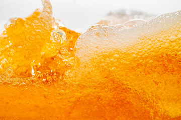Close up bright orange Oil or beer splash texture and nature waves, Beautiful waves curve and...