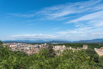 Fototapeta premium Landscape of Girona from the distance with mountains in the background on a nice day of summer