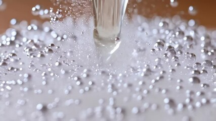 Powdered sugar pile with small droplets falling and landing in slow motion, macro view of granulated sugar and liquid - Powered by Adobe