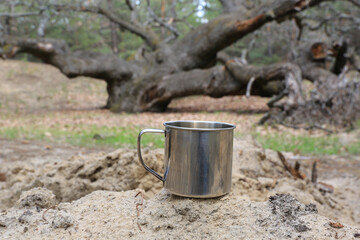 steel tourist mug in the forest