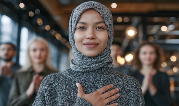 A Middle Eastern woman in a hajib is gesturing Break The Bias alongside her female friends in celebration of International Women's Day