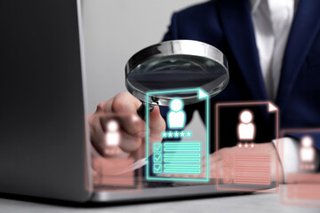 Recruitment, employee search. Human resources manager with magnifying glass using laptop, closeup. Virtual resumes above computer