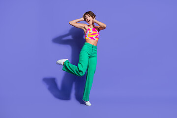 Obraz premium Photo of cheerful good mood pretty shiny woman wear bright clothes have fun summer friday weekend isolated on purple color background