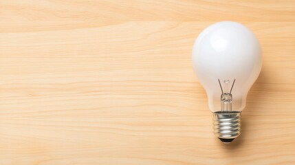 Bright White Light Bulb on Wooden Surface for Creative and Innovative Concepts