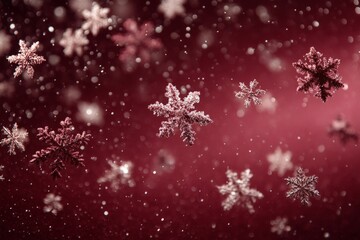 Fototapeta premium Snowflakes gently falling against a rich red background during winter celebrations at dusk in December