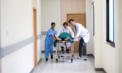 Obraz premium emergency hospital, Group of diverse man and woman medics or doctors Push Stretcher with Seriously Patient to Operating Room, Emergency Department