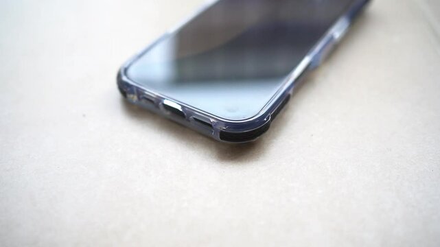 Smartphone in shockproof silicone case on tiled floor after falling.