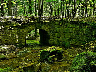 Czech Republic - view of the historic stone bridge over the Slatinsky stream in the forest near the village of Slatina