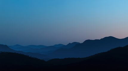 Obraz premium Mountain silhouette under twilight sky, serene blue tones blending into dusk, nature's quiet grandeur