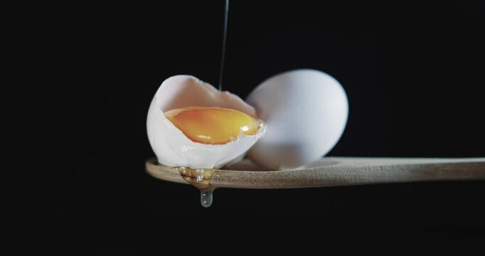 A close up of an egg with the yolk visible