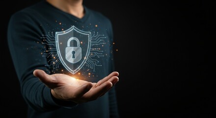 A person holding a glowing shield symbolizing cybersecurity and protection.