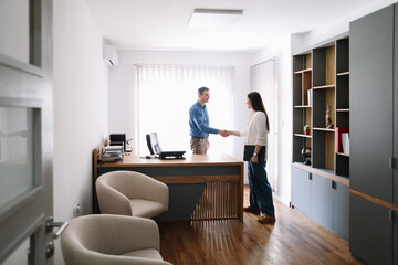 Business partners conclude meeting with firm handshake