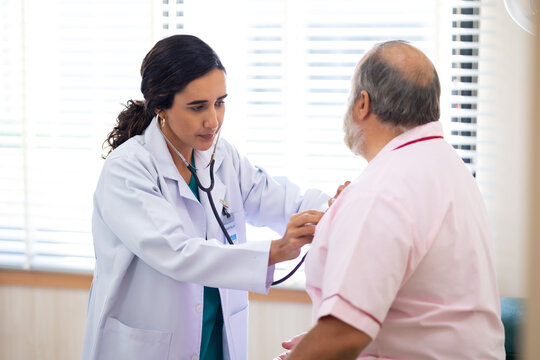 check up : Hispanic female nutritionist giving checking up to fat man stroke patient, Preventive Medicine Health Check-up in Progress