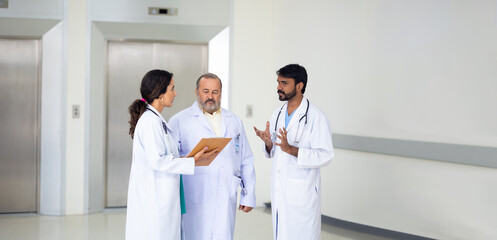 teamwork concept : Group of professional doctors meeting discussing diagnosis, checking test results in clinic. Medical staff, healthcare