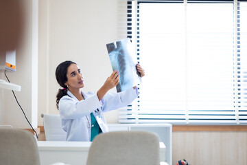 x-ray, Radiologist : Hispanic latin female doctor looking at x-ray film.  ct scan, mri, Woman radiologist checking investigating patient`s lungs on image. coronavirus treatment