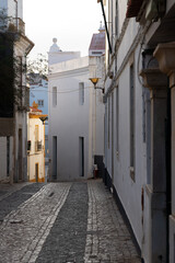 Street in the beautiful city of Lagos in the Algarve region of Portugal at sunset.