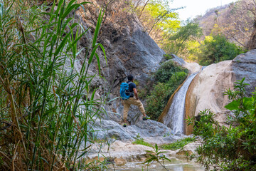 Tourist admiring stunning waterfall in puebla, mexico