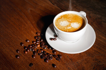 Coffee cup and coffee beans on wooden table, Espresso Crema coffee cup aromatic