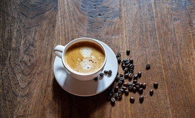 Coffee cup and coffee beans on wooden table, Espresso Crema coffee cup aromatic