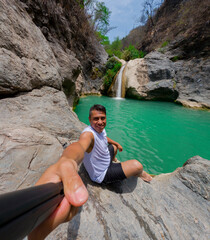 Tourist taking a selfie at la magdalena waterfalls