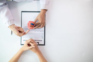 doctor is asking about patient information and symptoms to diagnose brain diseases before consulting patient and diagnosing correct treatment. doctor is consulting patient about brain problems.